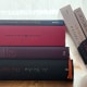 Stapel von vier B&uuml;chern, zwei B&uuml;cher lehnen seitlich am Stapel