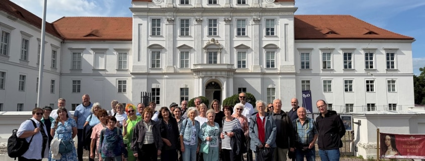 Eine Gruppe von Männern und Frauen vor dem Schloss Oranienburg